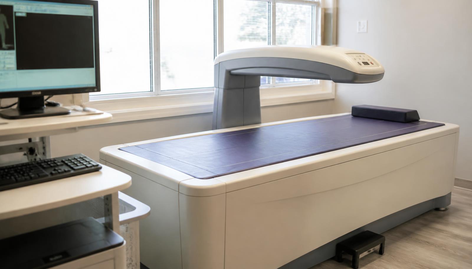A DXA scanner in a clinic room — the measurement is done lying down, fully clothed.